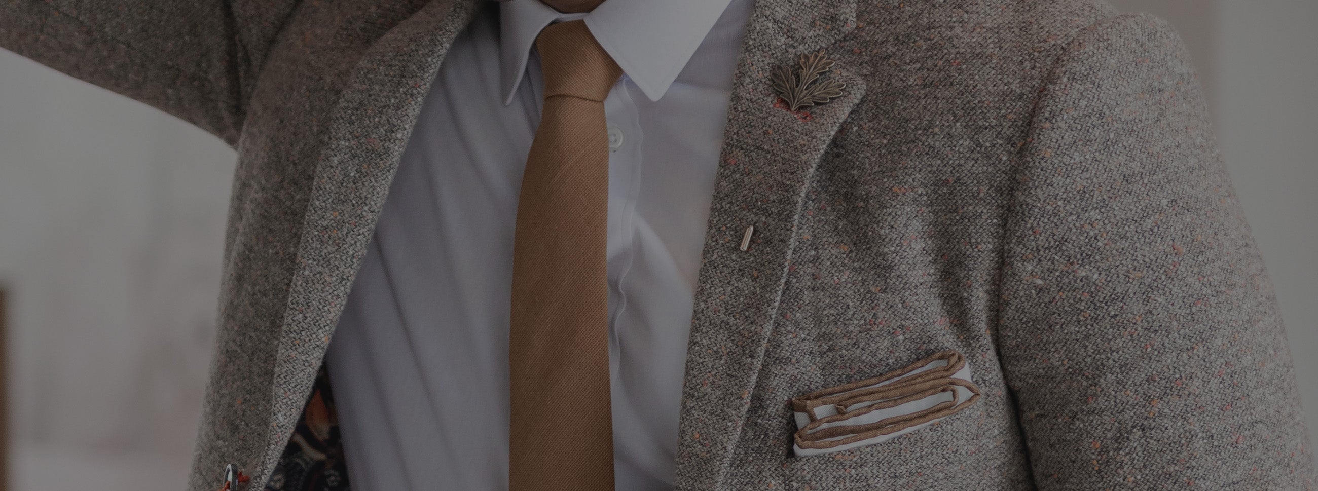 Man wearing a brown suit and a brown tie