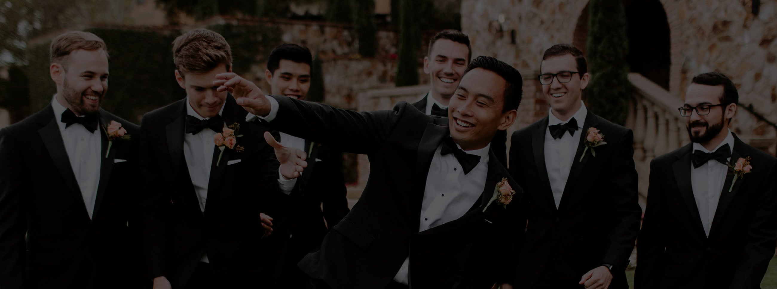 Group of groomsmen wearing black bow ties and black tuxedos