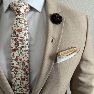 Floral Rust Bloom Tie with a tan suit and a brown rose lapel pin