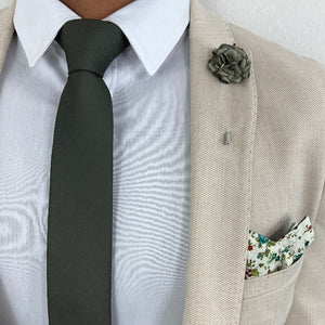 Herringbone Olive Tie with a tan suit and Sage Green Rose Lapel Pin